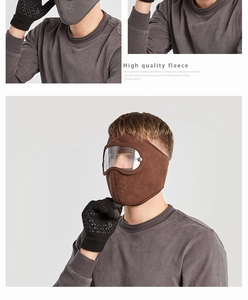 Detail of fleece mask with anti-fog goggles and knitted gloves for winter sports