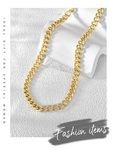 Macro detail of 18K gold plated curb chain necklace with sparkling zircon pavé