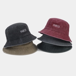 Close-up of vintage washed cotton bucket hats with Paris embroidery in multiple colors