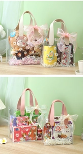 Detail of transparent PVC gift bag with daisy pattern and reinforced handles