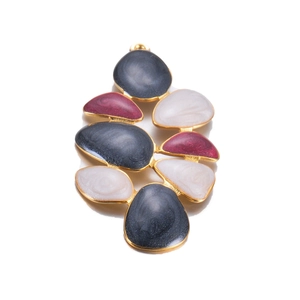 Macro view of gold-framed enamel flower earring with dark grey and burgundy details