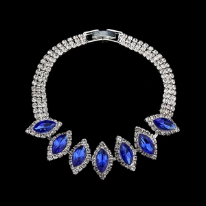 Sparkling bridal necklace with three rows of silver rhinestones and marquise blue gemstones