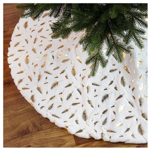 Detail of white faux rabbit fur Christmas tree skirt with elegant golden feather patterns