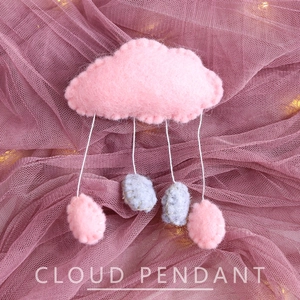 Pink felt cloud hanging ornament with raindrop pendants on purple mesh background