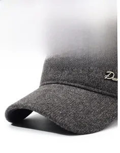 Detail of dark grey wool baseball cap showing rigid brim and metallic side decoration