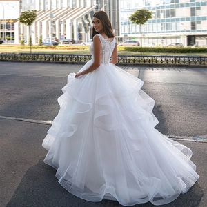 Elegant white ball gown wedding dress with lace bodice and voluminous tiered tulle skirt
