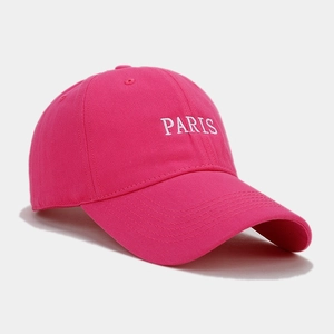Detail of white PARIS embroidery on hot pink cotton twill baseball cap with stitching