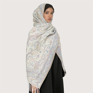 Close-up of the intricate paisley pattern and fringe detail on this soft winter shawl
