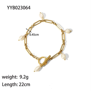 Detail view of 18K gold plated paperclip chain bracelet with baroque pearls and OT clasp
