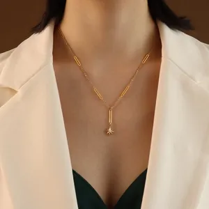 18K gold-plated starburst tassel necklace with elongated oval link chain on model