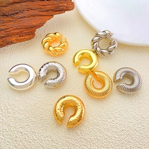 Minimalist C-shaped gold and silver ear cuff set with textured and smooth finishes