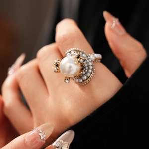 Macro shot of vintage flower ring with large center pearl and antique bronze metal