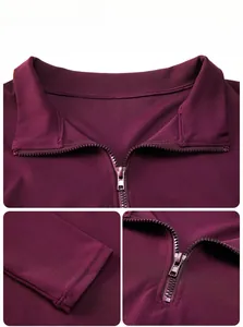 Detail of burgundy quarter-zip yoga top showing smooth fabric texture and metal zipper