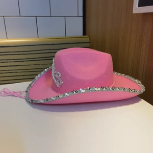 Detail of pink cowgirl hat featuring silver sequins and sparkling rhinestone crown