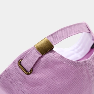 Detail of light purple baseball cap featuring adjustable metal buckle and cotton twill texture