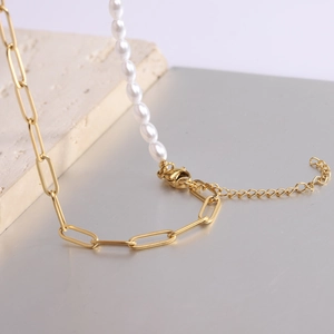 Close-up of gold paperclip chain and white pearl necklace with adjustable lobster clasp