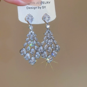 Close-up of sparkling silver tassel earrings with marquise and pear-cut cubic zirconia
