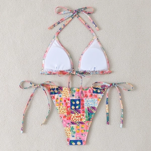 Detail of vibrant tropical bikini with fruit prints and adjustable side ties