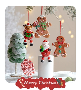 Close-up of festive gingerbread man and reindeer pendants hanging on Christmas tree branches