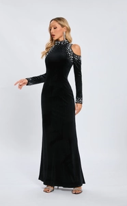 Detail of elegant black velvet dress with pearl and rhinestone accents on shoulders