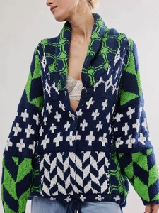 Close-up of geometric jacquard knit pattern on deep blue and green Y2K cardigan sweater