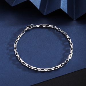 Close-up of silver stainless steel box chain bracelet with secure lobster clasp