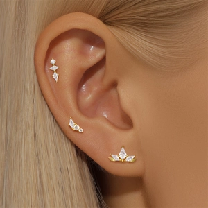 Macro view of gold S925 silver ear studs set with opal and marquise cubic zirconia