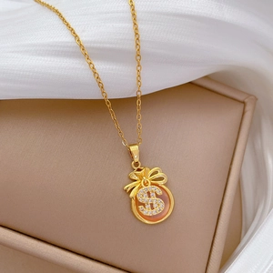 Close-up of gold fortune bag necklace featuring sparkling pavé crystals and orange gemstone