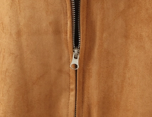 Close-up of a tan faux suede jacket featuring a high-quality silver metal zipper detail