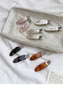 Detailed close-up of acetate teardrop hair clips with sparkling colorful rhinestones