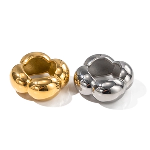 Chic 18K gold and silver stainless steel hollow flower rings for women on white backdrop