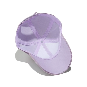 Detailed interior view of light purple sequin baseball cap with adjustable strap and stitching