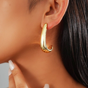 Glossy gold geometric U-shaped stud earrings for women featuring a minimalist fluid design