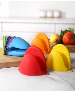 Colorful silicone mini oven mitts with non-slip texture on a kitchen countertop