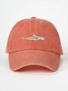 Detailed close-up of shark embroidery on a vintage orange washed cotton baseball cap