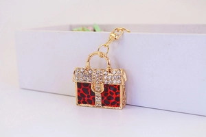 Detail of red leopard print handbag keychain with gold metal and sparkling rhinestones