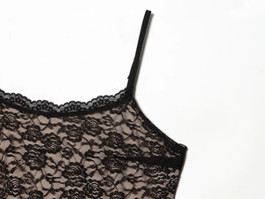 Dettaglio di un top in pizzo nero con spalline sottili e bordi smerlati di alta qualità
