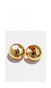 Detailed close-up of 24k gold-plated dome hoop earrings with a mirror-polished finish