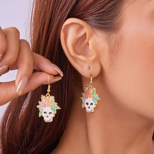 Close-up of Halloween skull earrings with colorful flowers on a model's ear