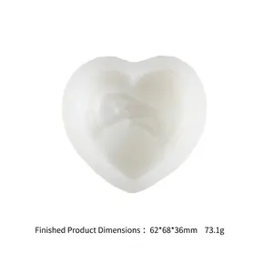 Detail view of heart-shaped silicone mold featuring a romantic hands-holding relief design