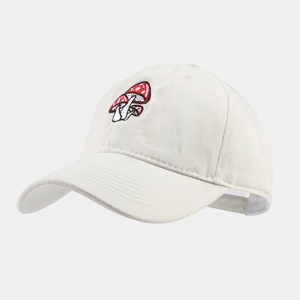 Close-up of fine red mushroom embroidery on a cream cotton baseball cap surface