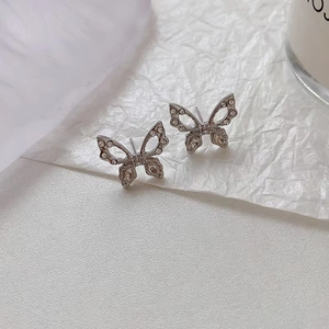 Detailed macro view of S925 silver butterfly earrings with sparkling cubic zirconia inlay