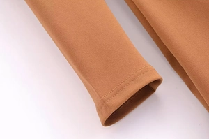 Detail view of camel long sleeve cuff featuring professional double stitching and fabric texture