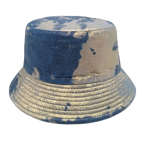 Detail of blue and gold tie-dye bucket hat with metallic coating and reinforced stitching