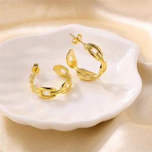Golden stainless steel coffee bean chain hoop earrings on a decorative shell tray