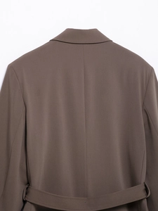 Detail view of the deep brown blazer back featuring high-quality fabric and waist tie design