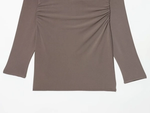 Detail of ruched side seams and ribbed texture on a deep brown V-neck knit mini dress