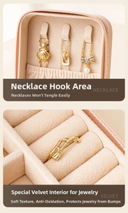 Detail of mini jewelry box featuring necklace hooks and velvet ring storage slots
