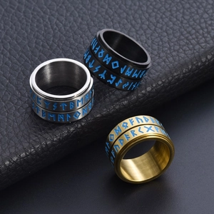 Viking rune stainless steel rotating rings in silver, black and gold on black leather
