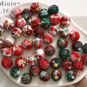 Close-up of Christmas plaid fabric beads with gold loops for DIY jewelry making